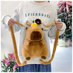 Cute capybara plush backpack with long straps held by a person for size reference