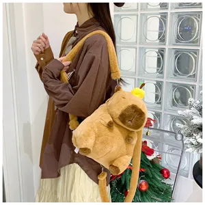 Close-up of cute plush capybara backpack with small apple decoration on head