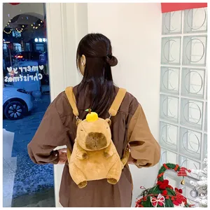 Close-up of a cute capybara plush backpack worn by a girl in a festive setting