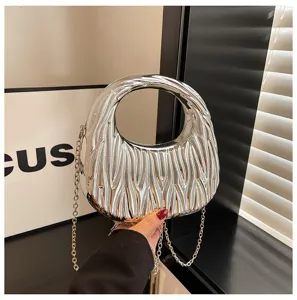 Close-up of metallic silver pleated handbag with circular handle and elegant chain strap