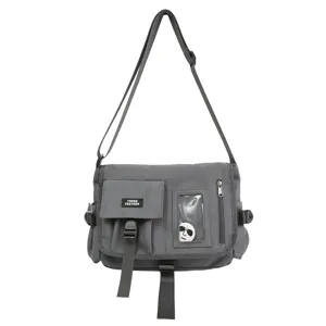 Close-up front view of a gray nylon utility messenger bag with THREE FEATHER label and straps