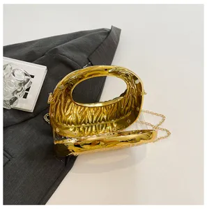 Luxury gold acrylic clutch handbag with chain strap, showing interior and metallic texture