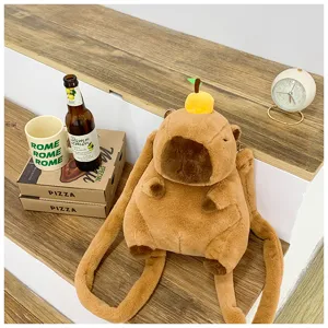 Detailed view of a cute capybara plush backpack with an orange on its head in a cozy setting