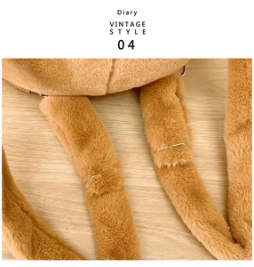 Detail view of the soft brown plush straps on the cartoon otter backpack for kids