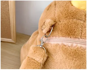 Close-up view of metal clasp and faux fur strap on a cute plush otter backpack