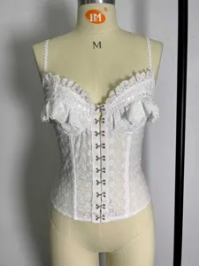 White lace corset top featuring hollow embroidery, delicate ruffles, and front metal hooks.