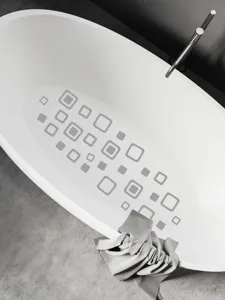 Detailed view of geometric square non-slip stickers applied inside a white oval bathtub