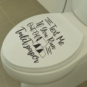 Creative toilet lid decal with 'Text Me If You Run Out Of Toilet Paper' humor quote