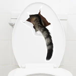 3D cat tail wall sticker applied on a white toilet lid for creative decoration