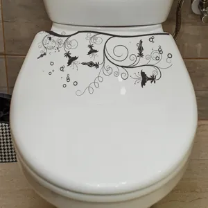 Vue détaillée d'un élégant autocollant de fleurs noires appliqué sur un abattant de WC blanc