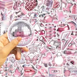 Hand holding a pink metallic disco ball sticker from a Y2K graffiti set