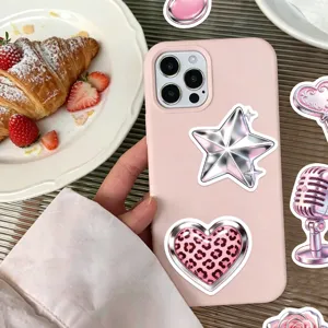Close-up of stylish metallic pink Y2K graffiti stickers decorating a mobile phone case