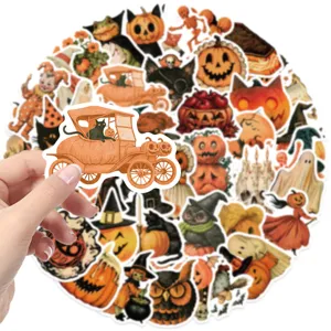 Close-up of a hand holding a vintage Halloween pumpkin car sticker from a 50pcs set