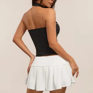Black halter corset top paired with white pleated mini skirt for a chic hot girl look