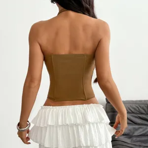 Brown halter corset top paired with white tiered ruffle mini skirt, sexy style detail view.
