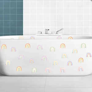 Detailansicht von Aquarell-Regenbogen-Aufklebern auf einer weißen Keramikbadewanne im Badezimmer