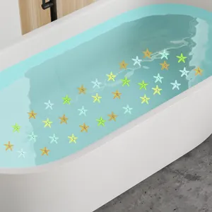 Colorful cartoon starfish anti-slip stickers applied inside a white bathtub filled with water.