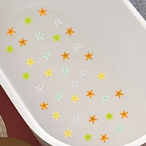 Multi-colored cartoon starfish anti-slip stickers shown inside a white bathtub