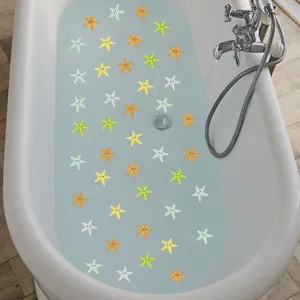 Cartoon starfish non-slip stickers applied inside a white bathtub for safety and decor.
