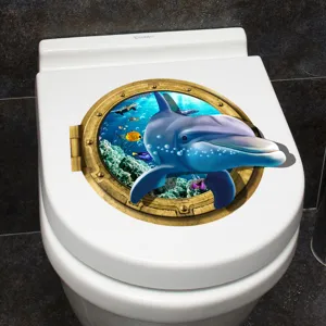 Detailed 3D dolphin porthole sticker applied to a white toilet lid for bathroom decoration.