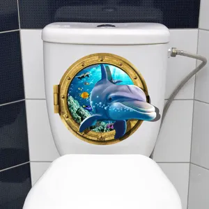 Detailed 3D dolphin porthole sticker applied to a white toilet tank in a bathroom.