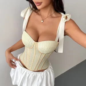 Top corset crème avec de jolies bretelles nouées en ruban et structure baleinée.