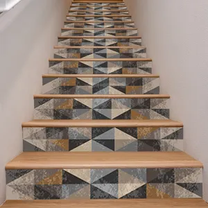 Close-up detail of 3D geometric patterned self-adhesive staircase riser stickers on stairs