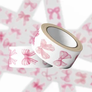 Detail view of decorative tape rolls featuring various watercolor pink bow patterns.