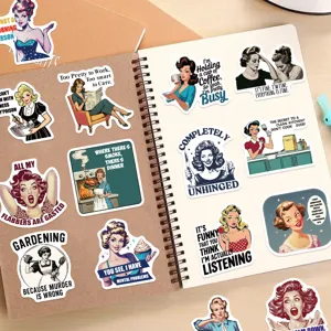 Close-up detail of retro cartoon female quote stickers on a brown spiral notebook