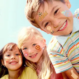 Cheerful children wearing glow-in-the-dark soccer tattoo stickers outdoors on a sunny day