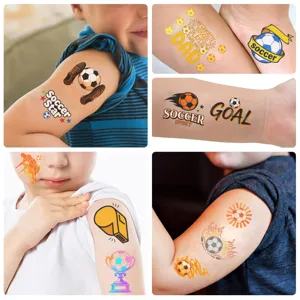 Kids arm with various soccer themed temporary tattoos including goal and star designs
