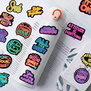 Detail shot of neon inspirational stickers applied on a white water bottle for DIY decor.