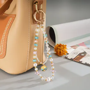 Close-up of double-layer beaded chain with iridescent crystals and colorful charm