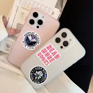 Holographic book-themed stickers with glitter finish on clear phone cases