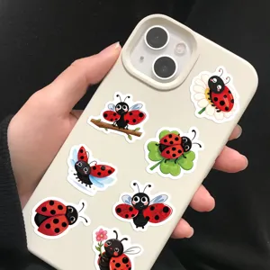Close-up view of vibrant cartoon ladybug stickers applied on a cream phone case