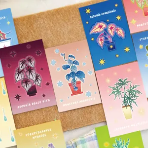 Close-up of vibrant magic plant postcards with botanical names on a cork board background.