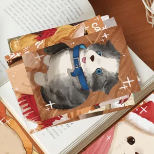 Close-up of cartoon pet postcards with a cute dog illustration resting on an open book
