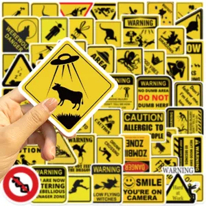 Close-up of a funny UFO cow warning sticker from a fifty-piece yellow waterproof sticker set.