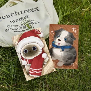 Detail view of cute cartoon pet postcards with festive cat and puppy designs on grass