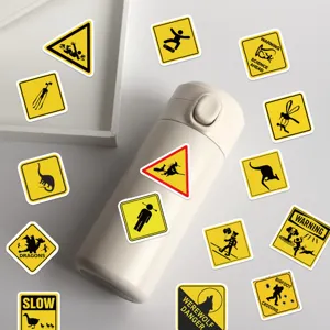 Detailed macro view of yellow waterproof funny warning sign stickers on a water bottle
