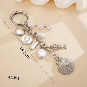 Detailed view of the ocean-themed zinc alloy keychain with shell and pearl charms.