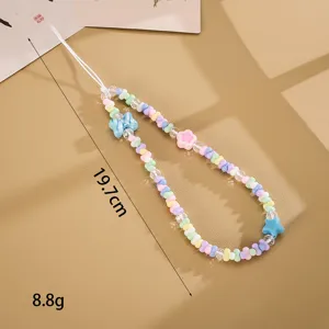 Detail view of handmade pastel beaded phone charm with butterfly and star accents
