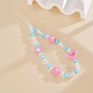 Detailed view of summer handmade beaded phone strap with pink heart and blue beads