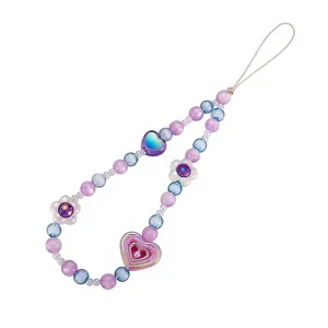 Handmade beaded phone strap with iridescent heart and flower charms in purple and blue tones.