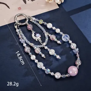 Close-up detail of luxury cat eye beaded phone charm with moon pendant and double chain