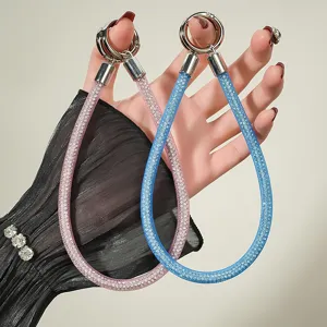 Close-up of luxury sparkling crystal mesh rope phone straps with metal ring buckles