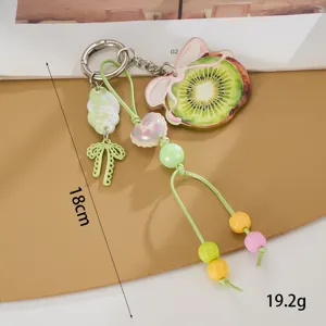 Detail van acryl kiwi schijf sleutelhanger met kleurrijke kralen en 18 cm lengte