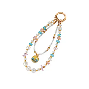 Detailed view of a double-layer beaded charm with iridescent crystals and white pearls.