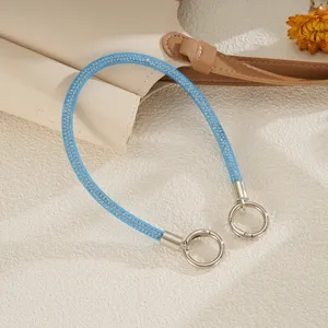 Close-up of light blue mesh rhinestone phone lanyard with silver circular clasps