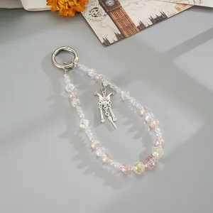 Detailed view of a pink and clear beaded phone charm with an elegant butterfly pendant.
